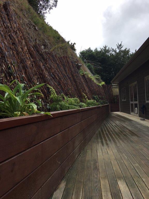 Raised timber garden bed beside a planted path